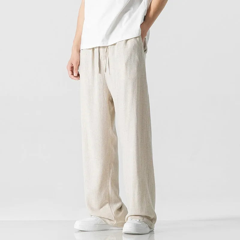 Men's beige linen-blend cropped trousers with a drawstring waist on a plain background.