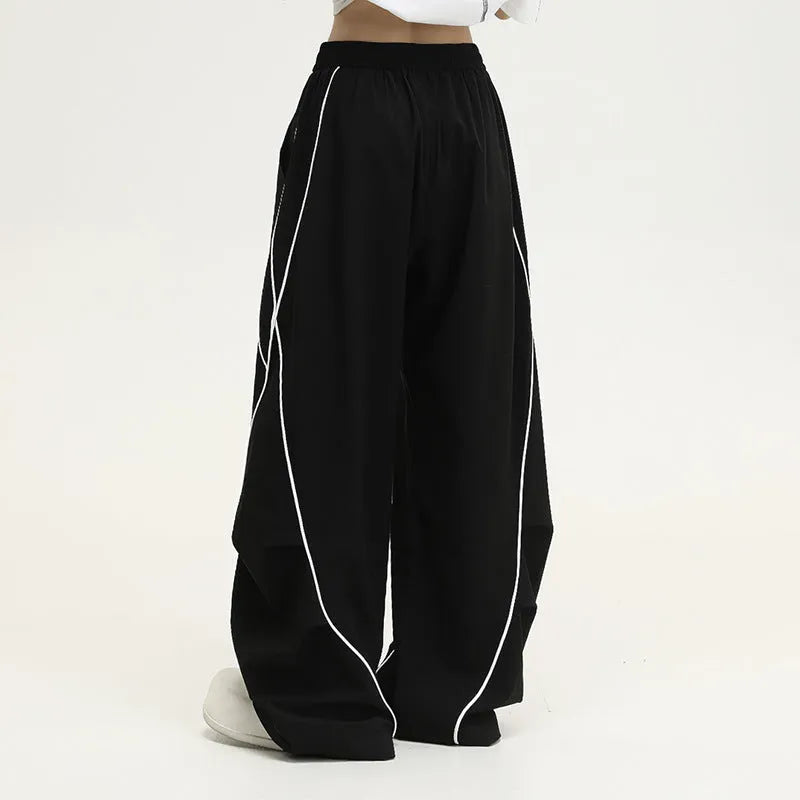 Black pleated wide-leg hip hop sports trousers with striped pattern on a mid waist.