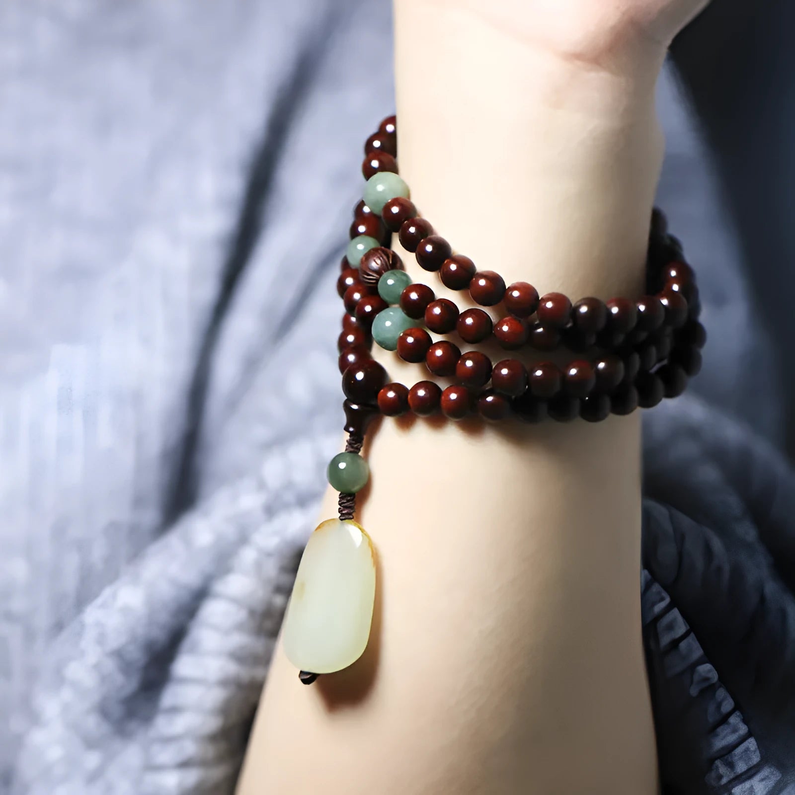 Traditional rosewood bead bracelet with 108 beads and a Hotian jade pendant.