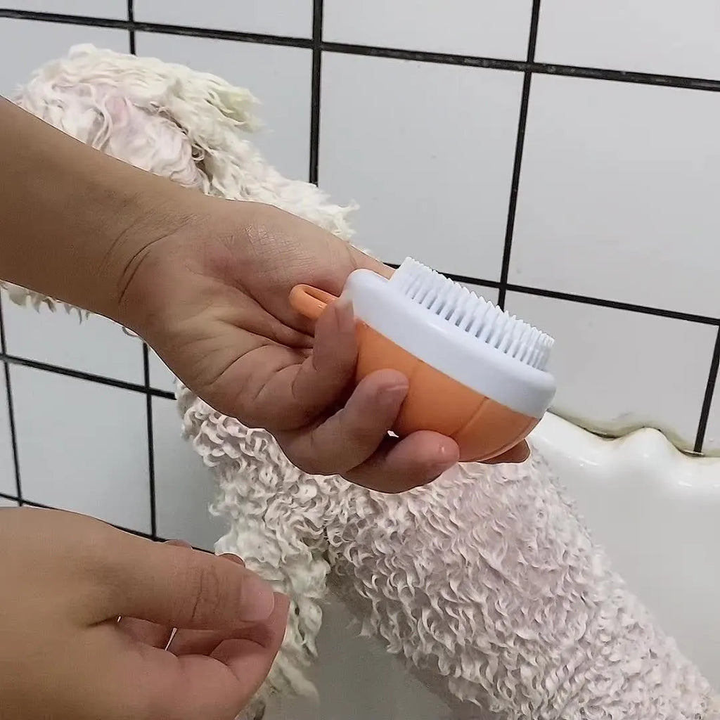 Orange TPR dog bath brush with shampoo dispenser and curved pumpkin grip design