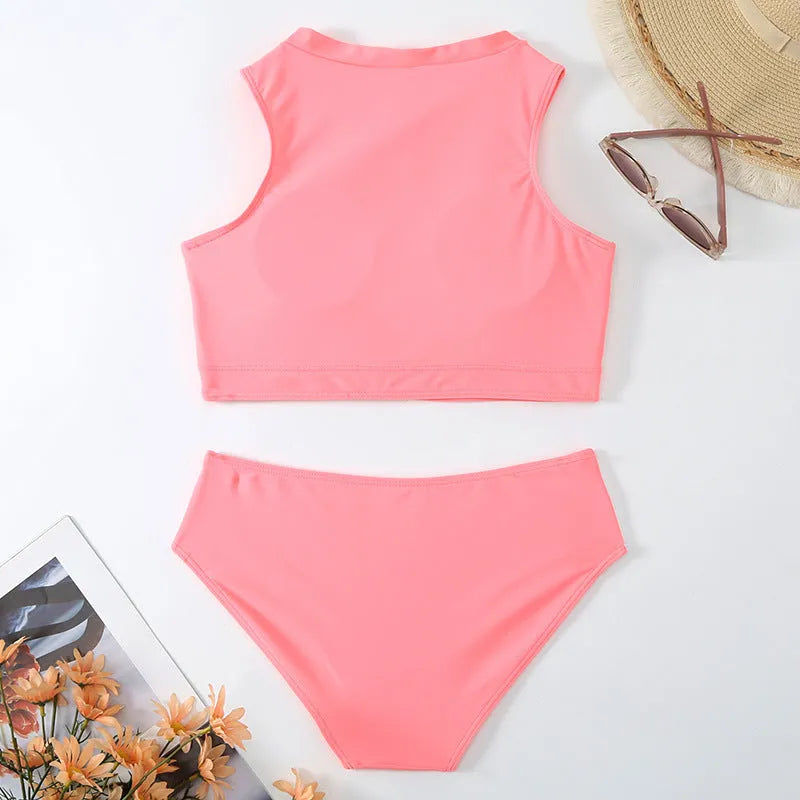 Pink high-waist bikini swimsuit with brief style shorts and a sleeveless top.