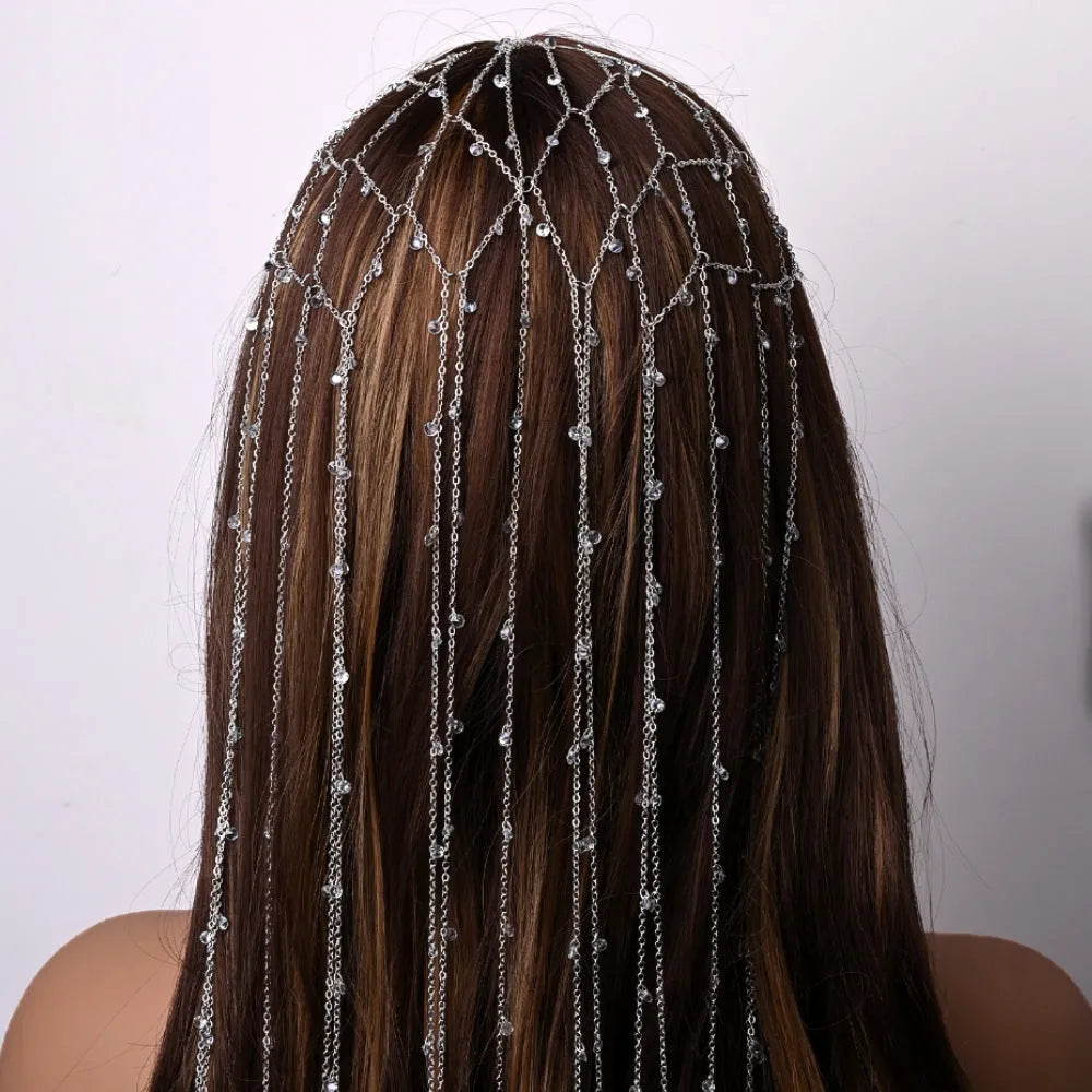 Gold and silver rhinestone headband with decorative tassel detail on mesh base
