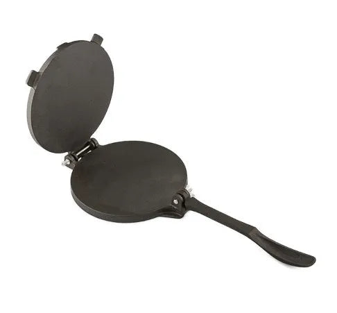 Round cast iron hand pressure cake press on a kitchen surface, available in sizes 16.5cm to 26cm diameter