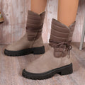 Women's black suede high-top snow boots with chunky rubber sole and lace-up design.