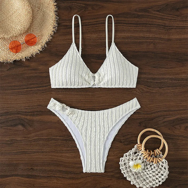 White women's V-neck swimsuit with split design for beach swimming.