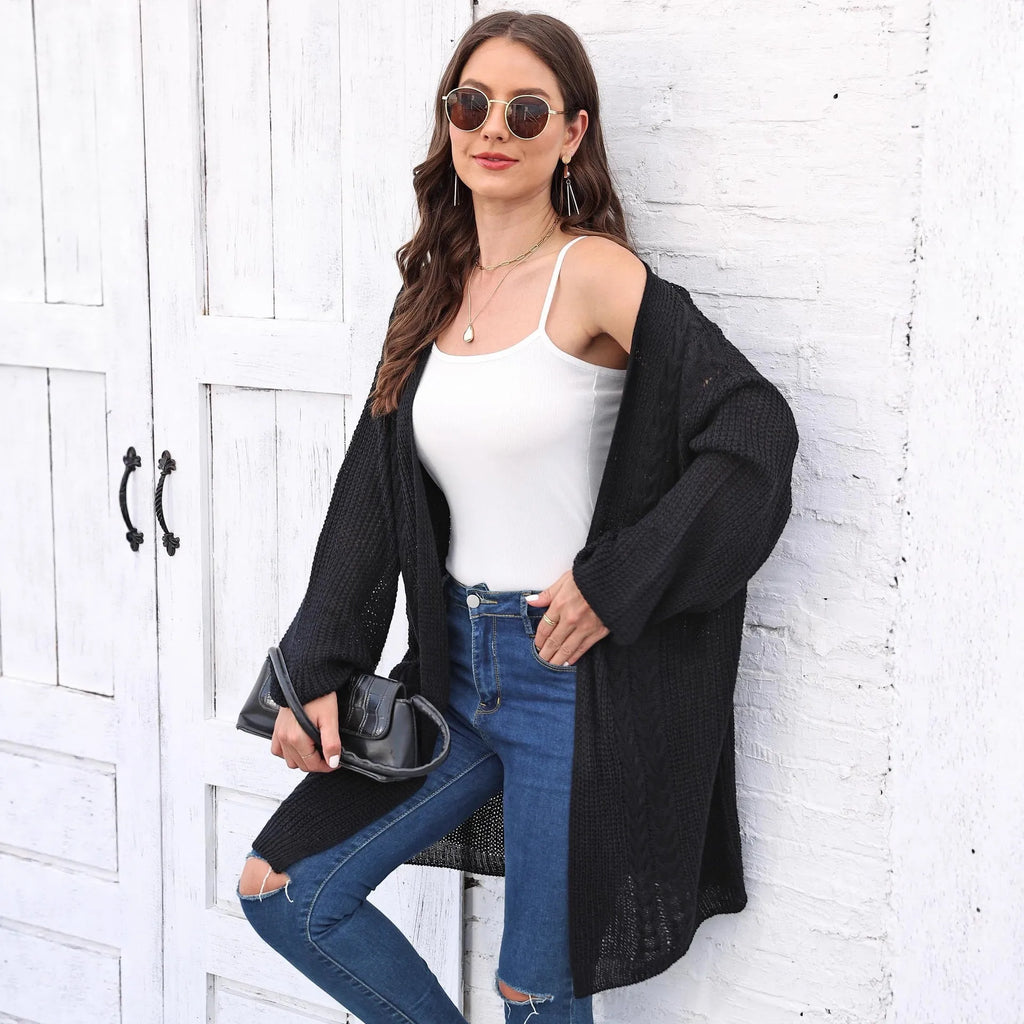 Loose-fit women's acrylic sweater coat in army green, shown on a hanger.