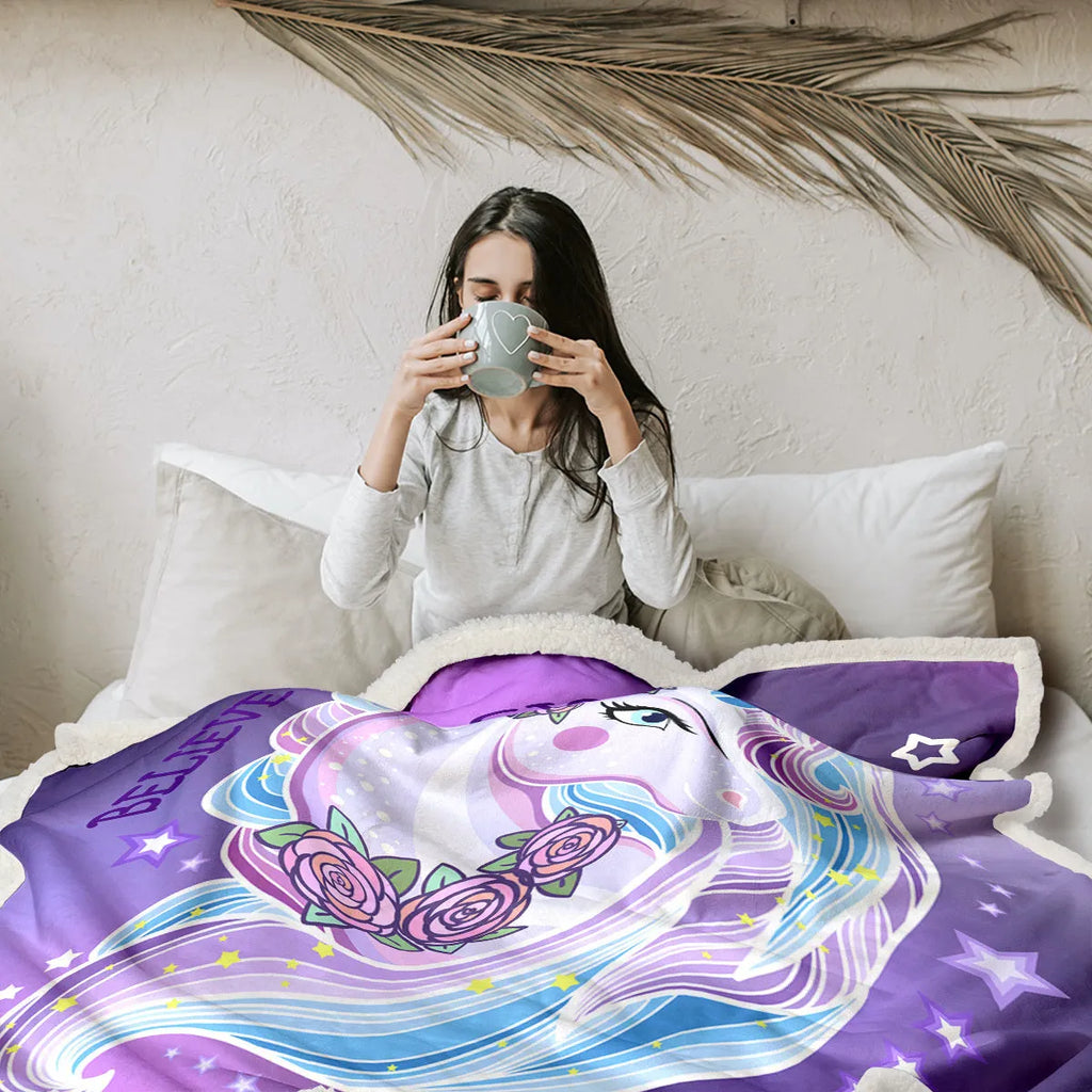 Purple unicorn themed sherpa fleece blanket with hemmed edges, available in 130x150cm and 150x200cm.