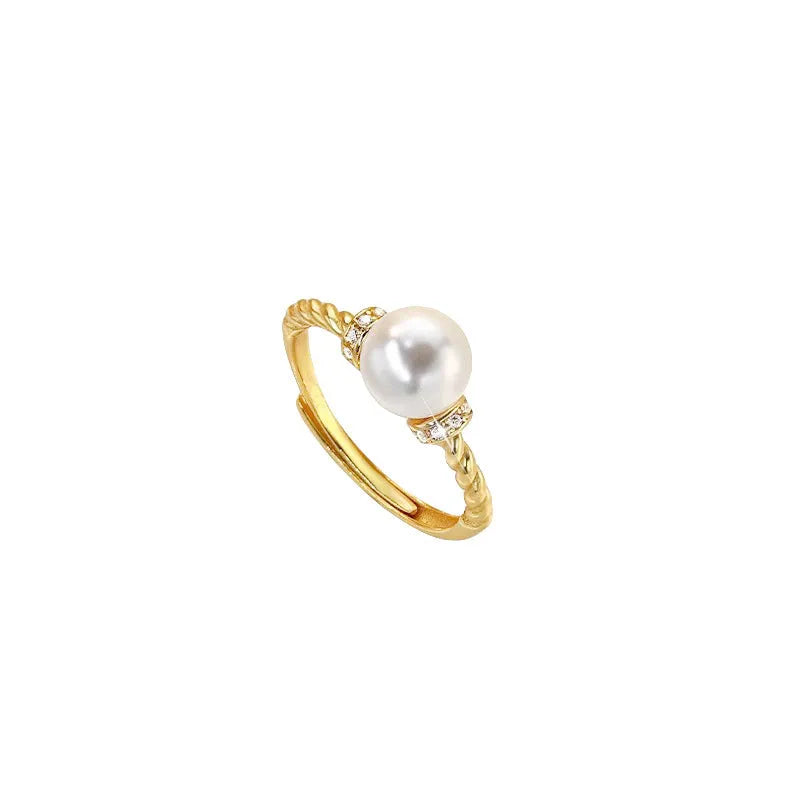 Adjustable antique-finish copper ring with a 6mm pearl set in a geometric twist.