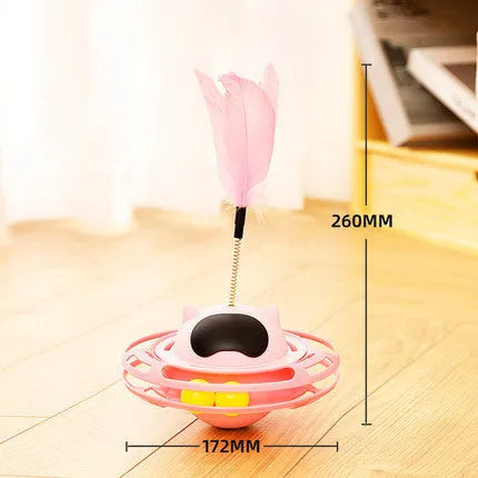 Pink cat tumbler turntable toy with feather attachments on rotation platform