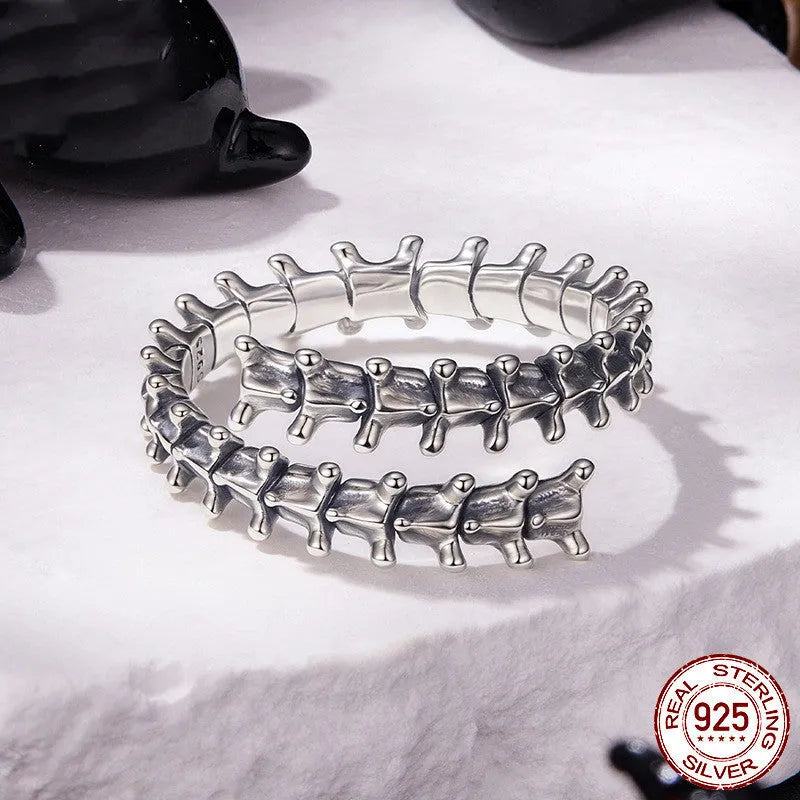Women's silver tone adjustable backbone open ring with pumpkin skull motif on black background