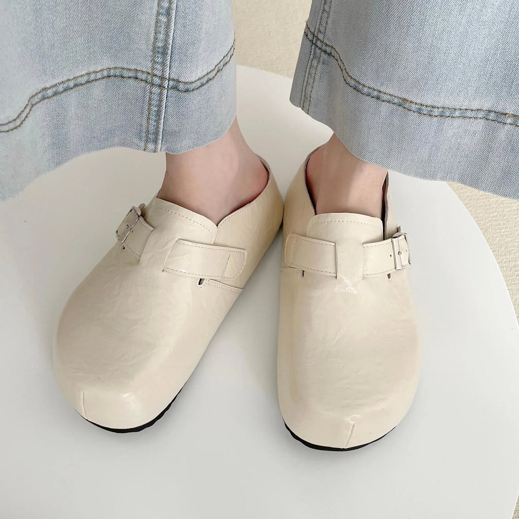 Flat buckle casual sneakers in yellow, creamy-white, silver, and black colours with round toe.
