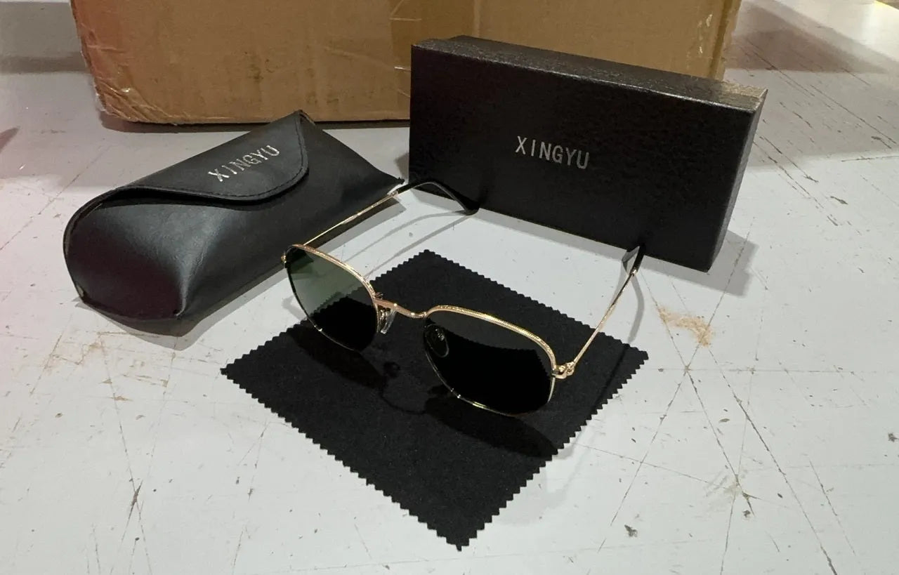 Men's classic round retro sunglasses in black frame on a grey background.