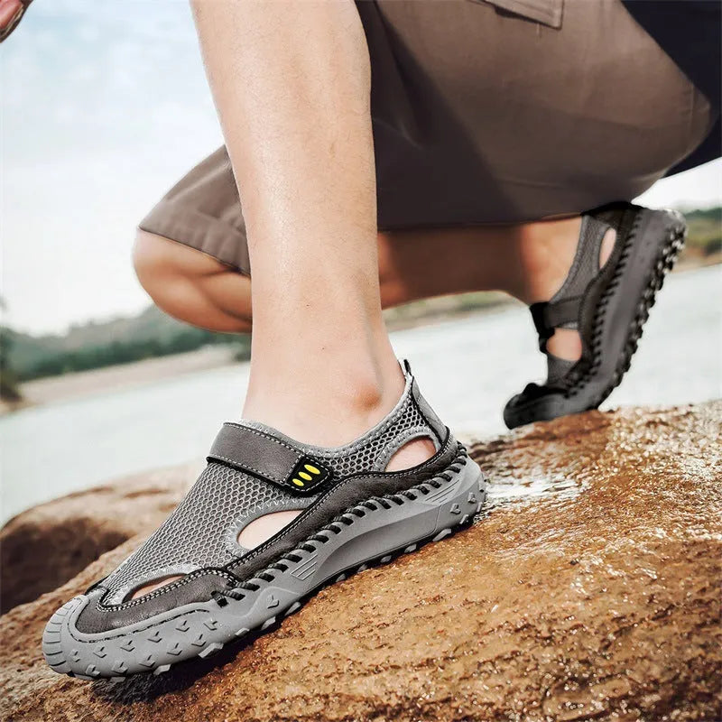 Men's black casual sandals with mesh upper and Velcro strap on a rubber sole.