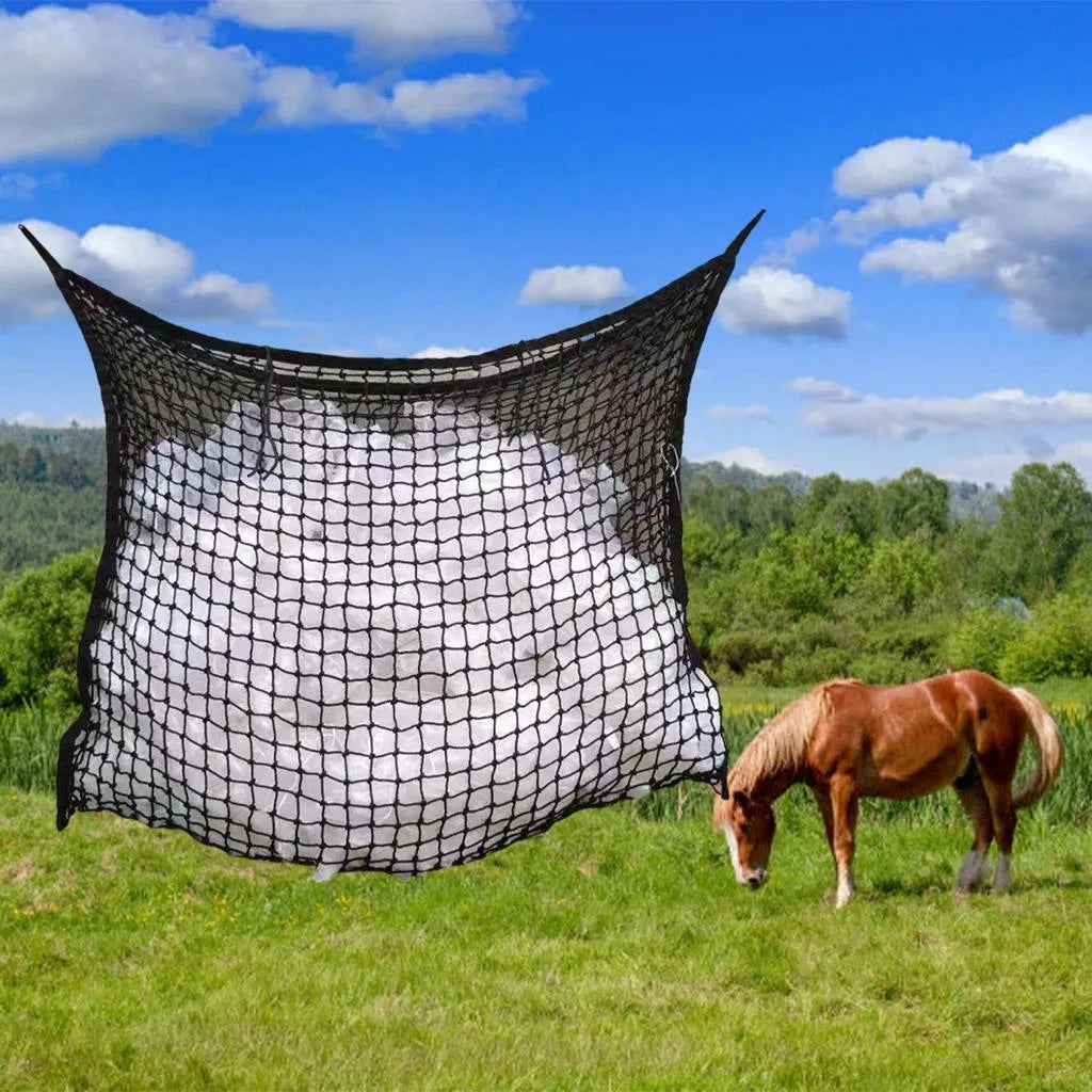 Black woven grid horse feeding bag hanging, filled with hay.