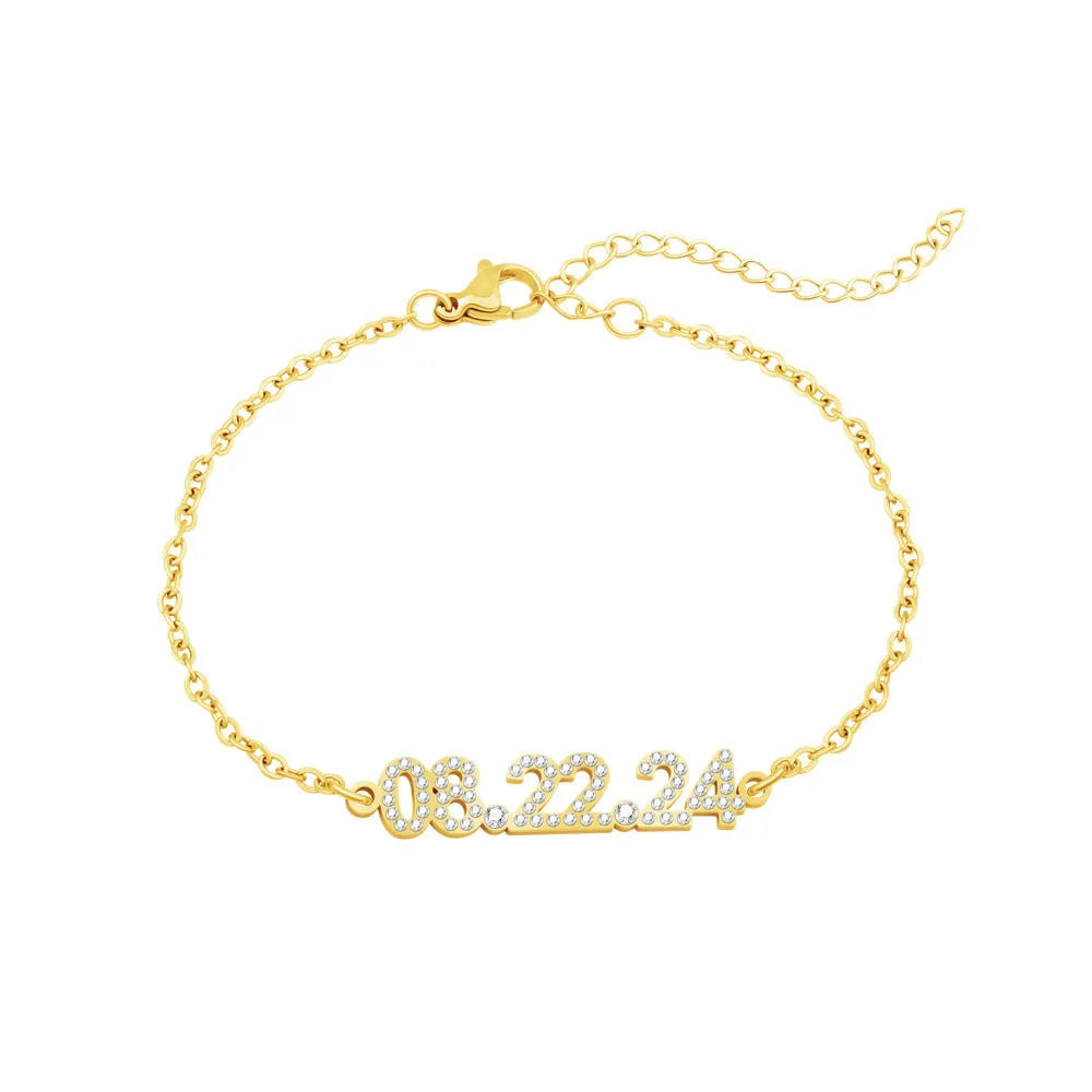 Stainless steel digital bracelet watch with diamond-set numbers on the face, shown in gold tone.