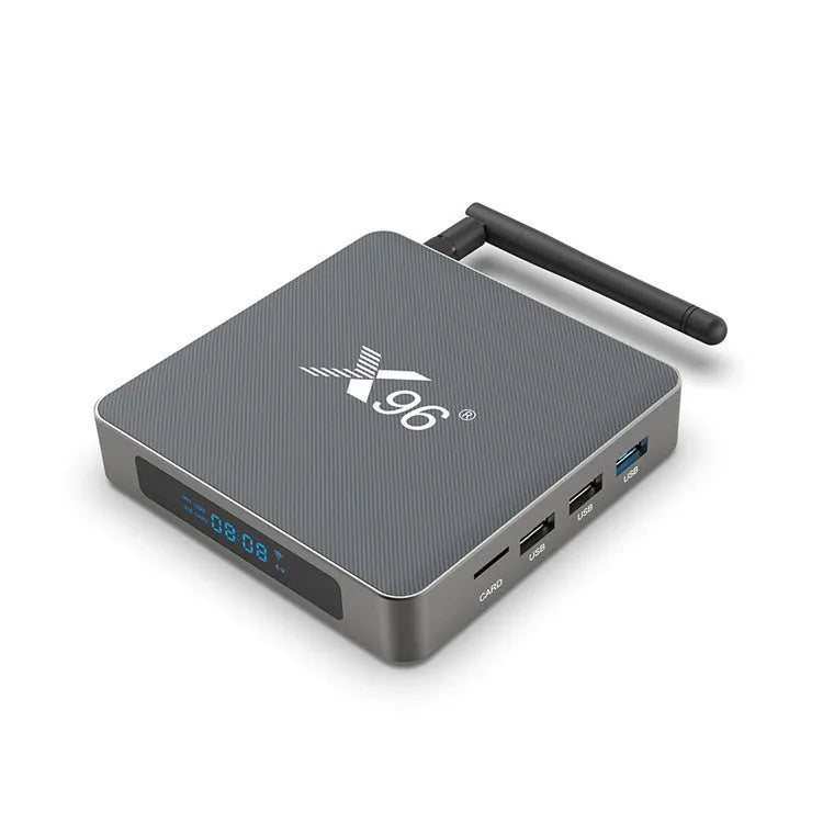 Android Smart TV set-top box with voice remote, HDMI cable, and power adapter on a table.