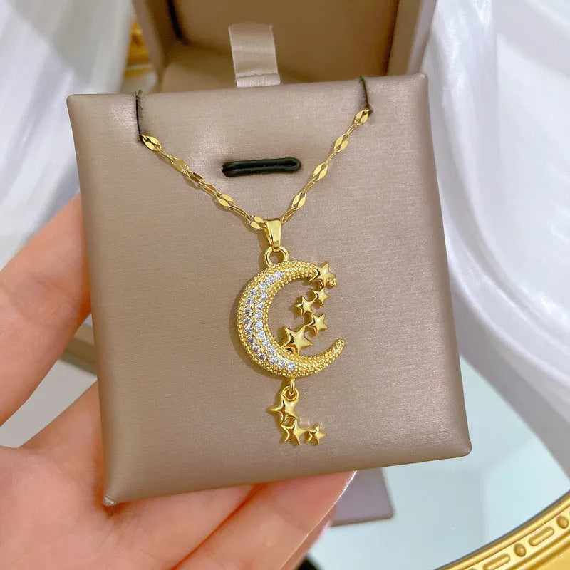 Geometric moon pendant necklace with tassel on a stainless steel chain, showing copper metal tone.