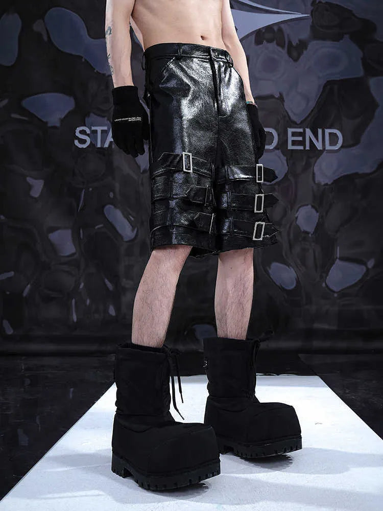Man's black PU leather-look cropped shorts with stretch spandex material on a neutral background.