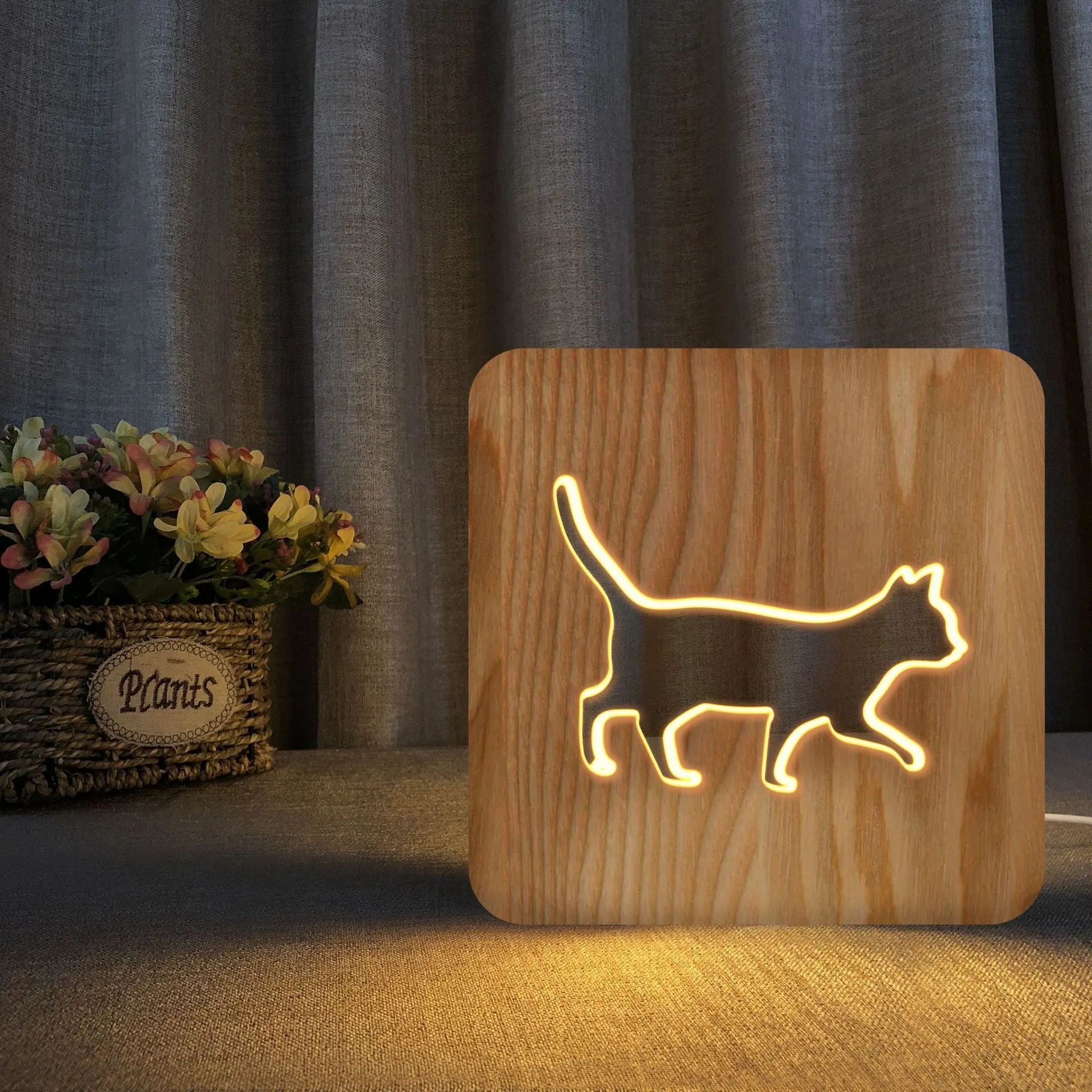 Solid wood 3D cat silhouette night light with hollow design and USB power cord.