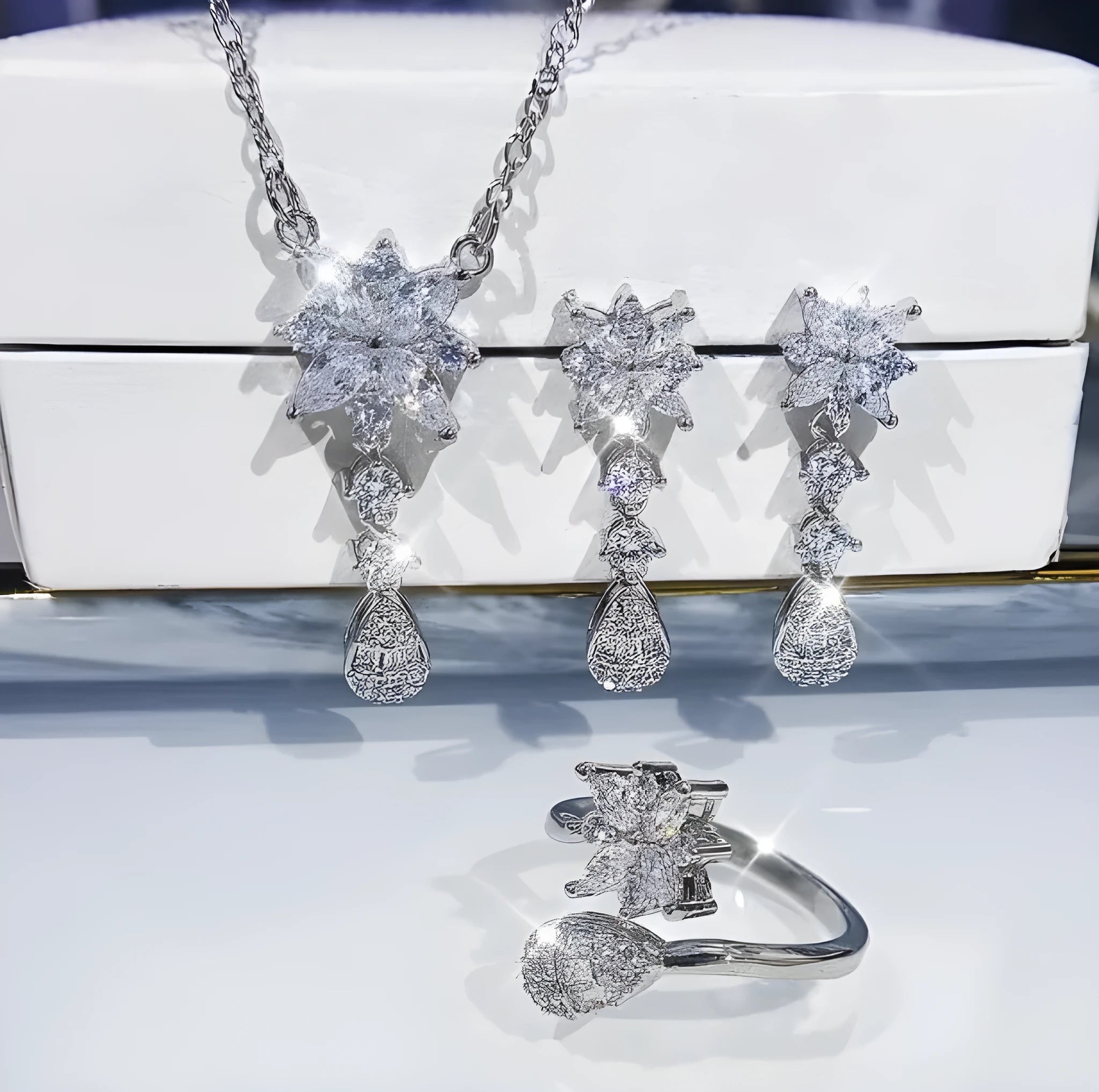 Floral zircon bridal jewellery set including ring, necklace with curb chain, and earrings on brass