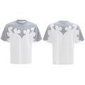 Close-up of a men's grey t-shirt with raised burnt flower embroidery and sparkling rhinestone details on the chest.