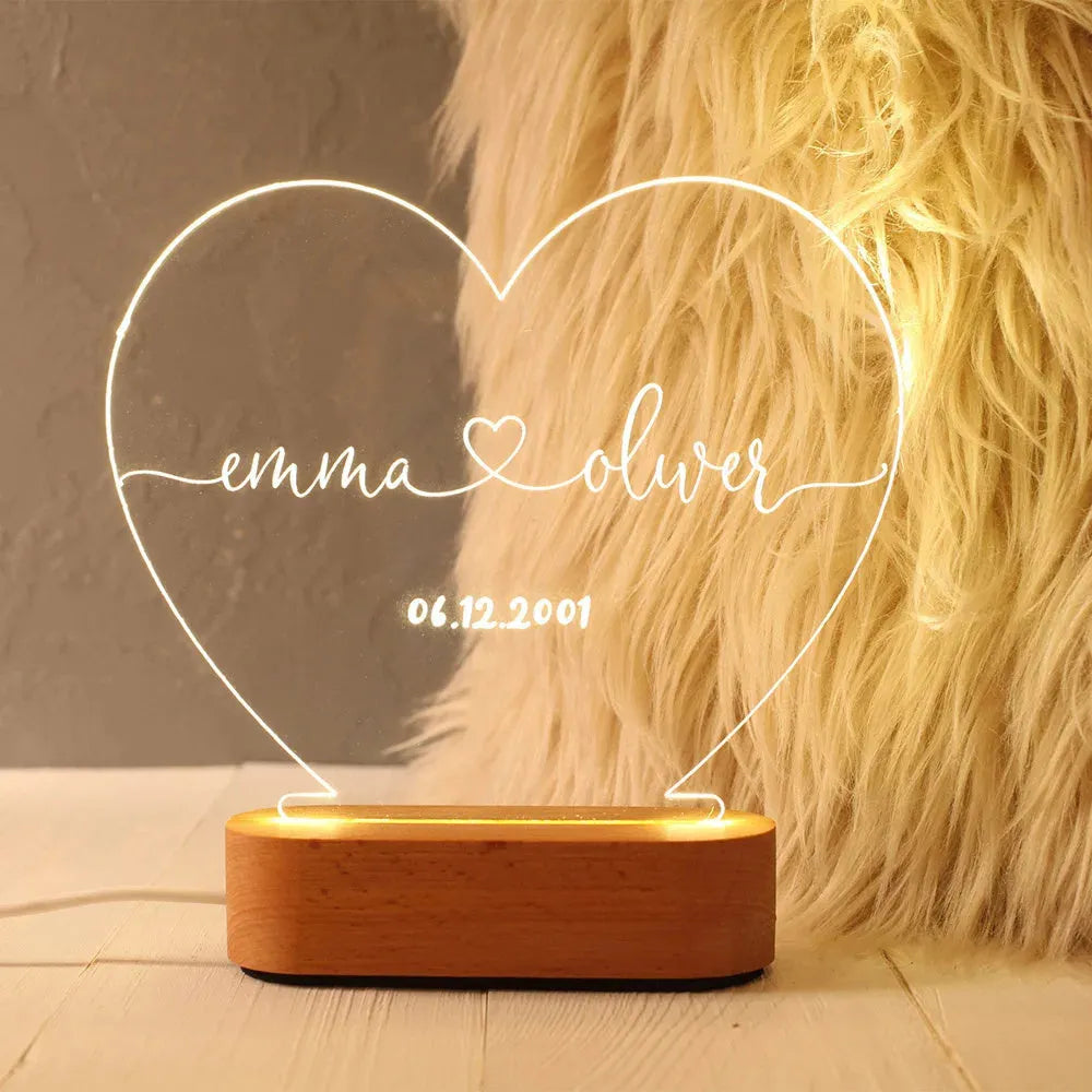 Custom transparent acrylic LED night light personalised with names and date, 20cm by 11.5cm.