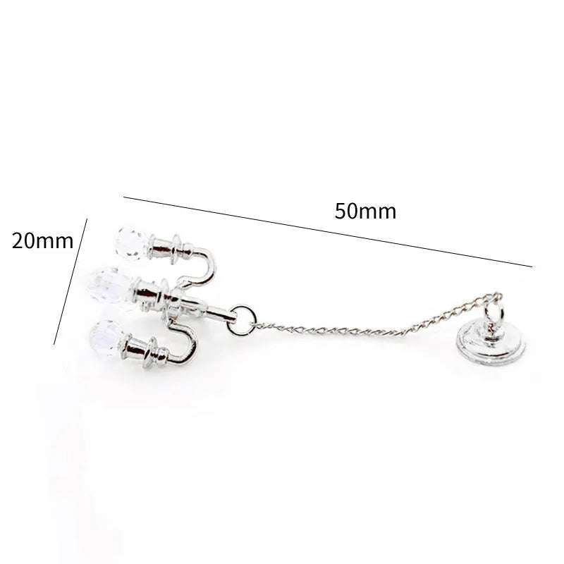 A small gold or silver metal photo prop decoration measuring 5 by 2 centimetres.