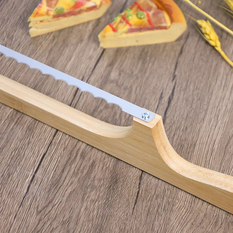 Wooden serrated bread knife with 40cm blade on a cutting board next to a loaf of bread