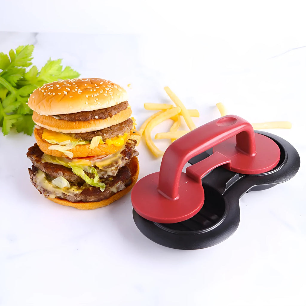 Black and red food-grade ABS plastic burger press mould on a kitchen counter.
