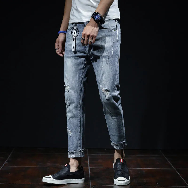 Light blue ripped jeans with straight leg, mid waist, and cropped length for youth
