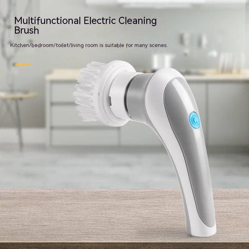 White cordless electric cleaning brush with multiple brush heads on a cleaning surface