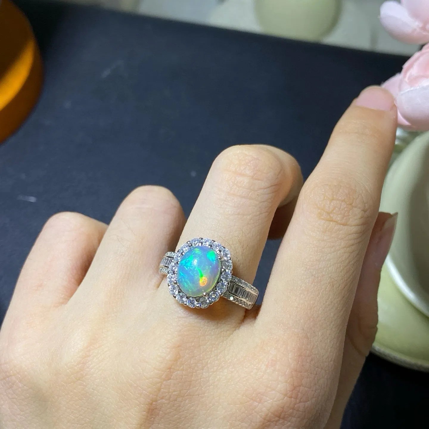 Handmade women's silver opal ring with an opening design, shown in a choice of colour plating.