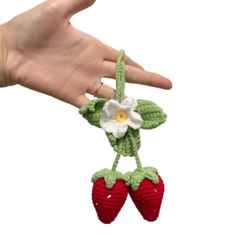 Handmade knitted strawberry-shaped car pendant made from cotton and hemp wool.