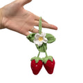 Handmade knitted strawberry-shaped car pendant made from cotton and hemp wool.