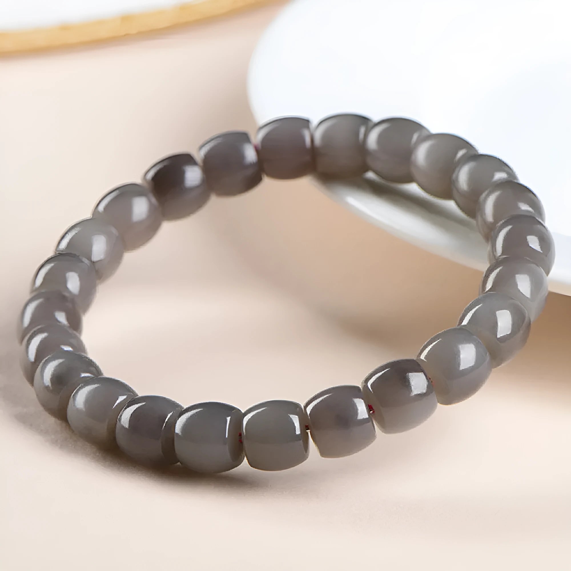 Natural smokey violet Hetian jade straight cut bead bracelet on wrist.