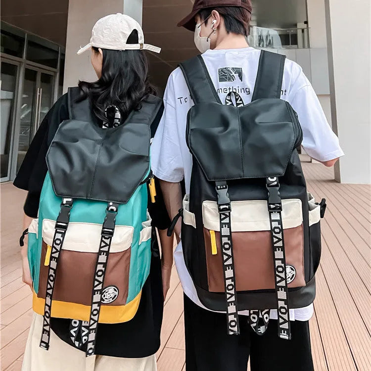 Oxford cloth backpack in black, green, or red, showing handheld and shoulder strap carry options