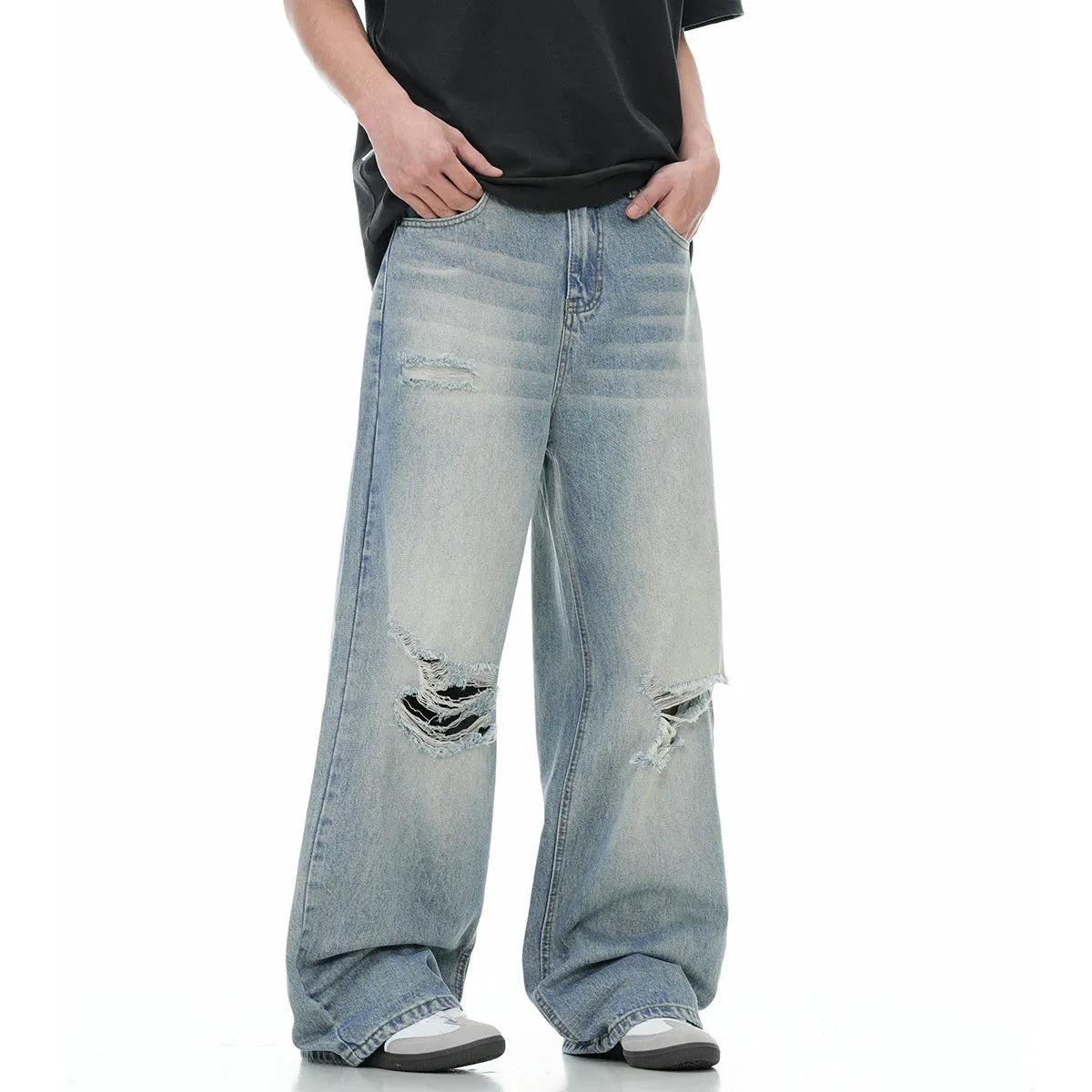 Men's blue straight-leg ripped jeans on a white background showing retro detailing and zip fly