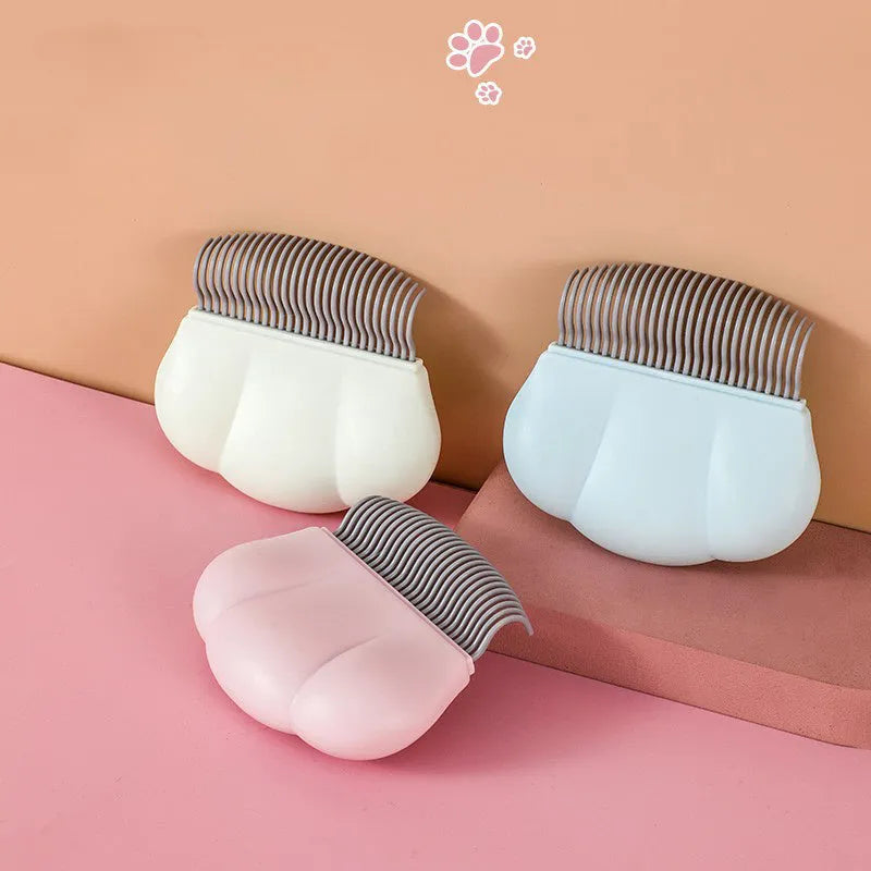Paw Soft deshedding brush tool for pets in blue, pink, or white, showing 9cm by 9cm head.