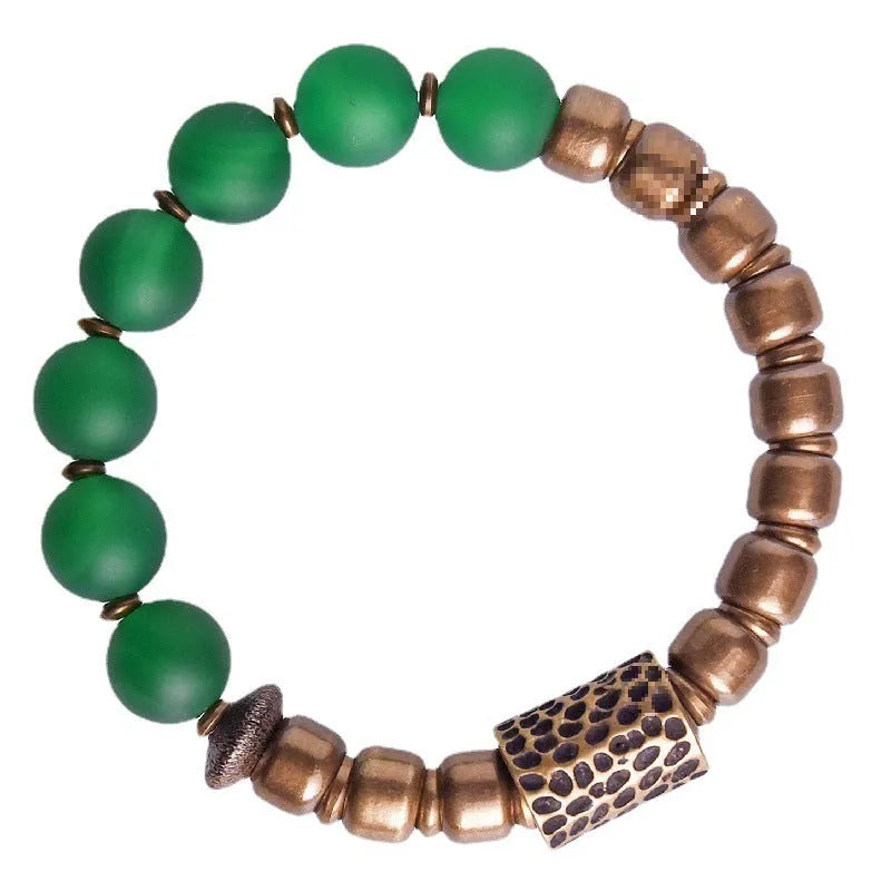 Retro ethnic style couples bracelet made from natural green agate beads on a wrist.