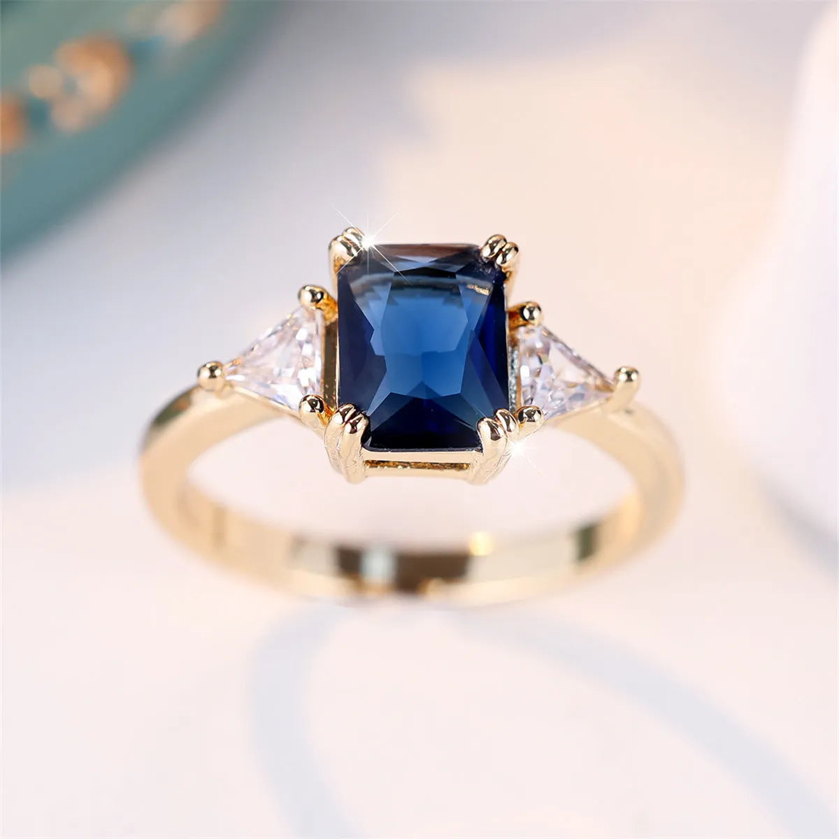 Copper rectangular fashion ring for women in gold sapphire blue colour