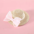 Cat wearing woven straw hat with pearl bow decoration in princess style