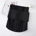Nylon belly band waist trainer in apricot colour with an adjustable tie, laid flat.
