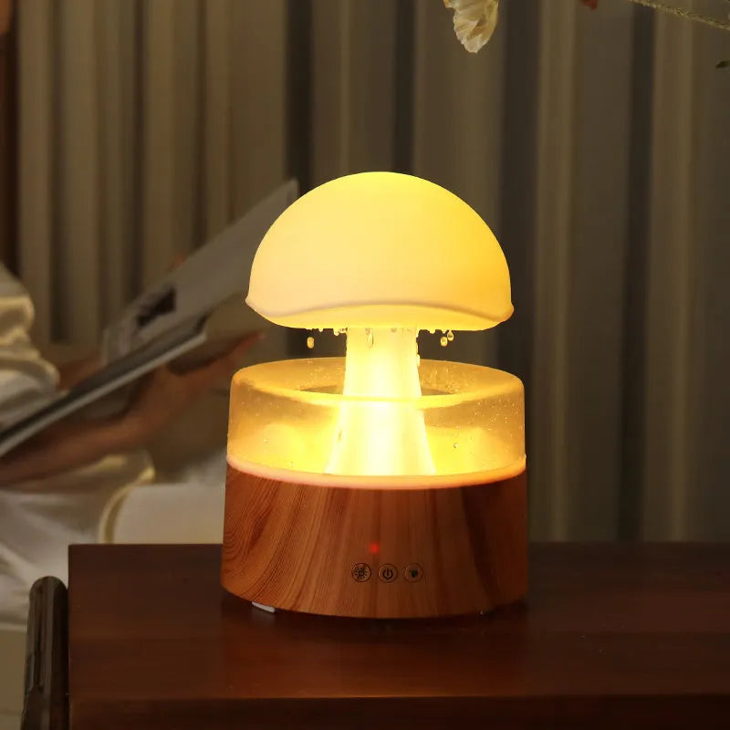 White cloud-shaped humidifier and aroma diffuser with falling water droplets and coloured lights