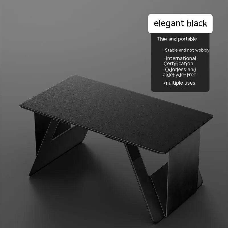 Foldable wooden laptop stand in black, raised on a desk with space underneath