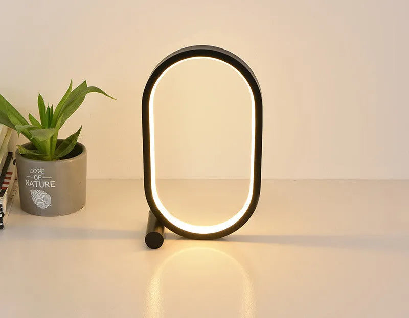 USB plug-in oval acrylic night light with touch control, metal base, and dimmable LED in black
