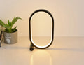 USB plug-in oval acrylic night light with touch control, metal base, and dimmable LED in black