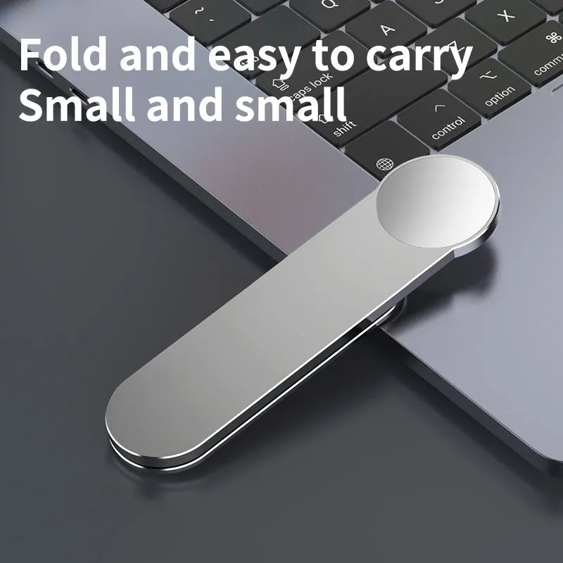 Silver aluminium alloy dual screen extension bracket with magnetic phone mount next to a laptop