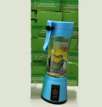 Pink portable USB rechargeable blender with six blades and a 380ml transparent cup on a table.