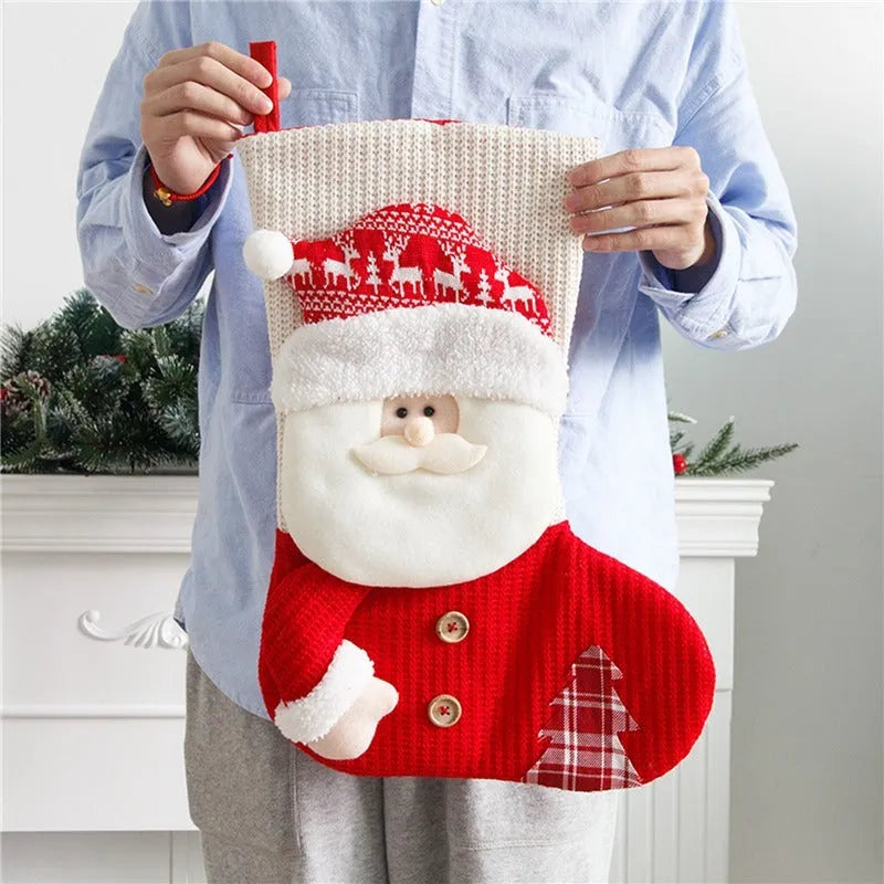 Large red and white knitted Christmas stocking with Santa Claus design hanging on a fireplace