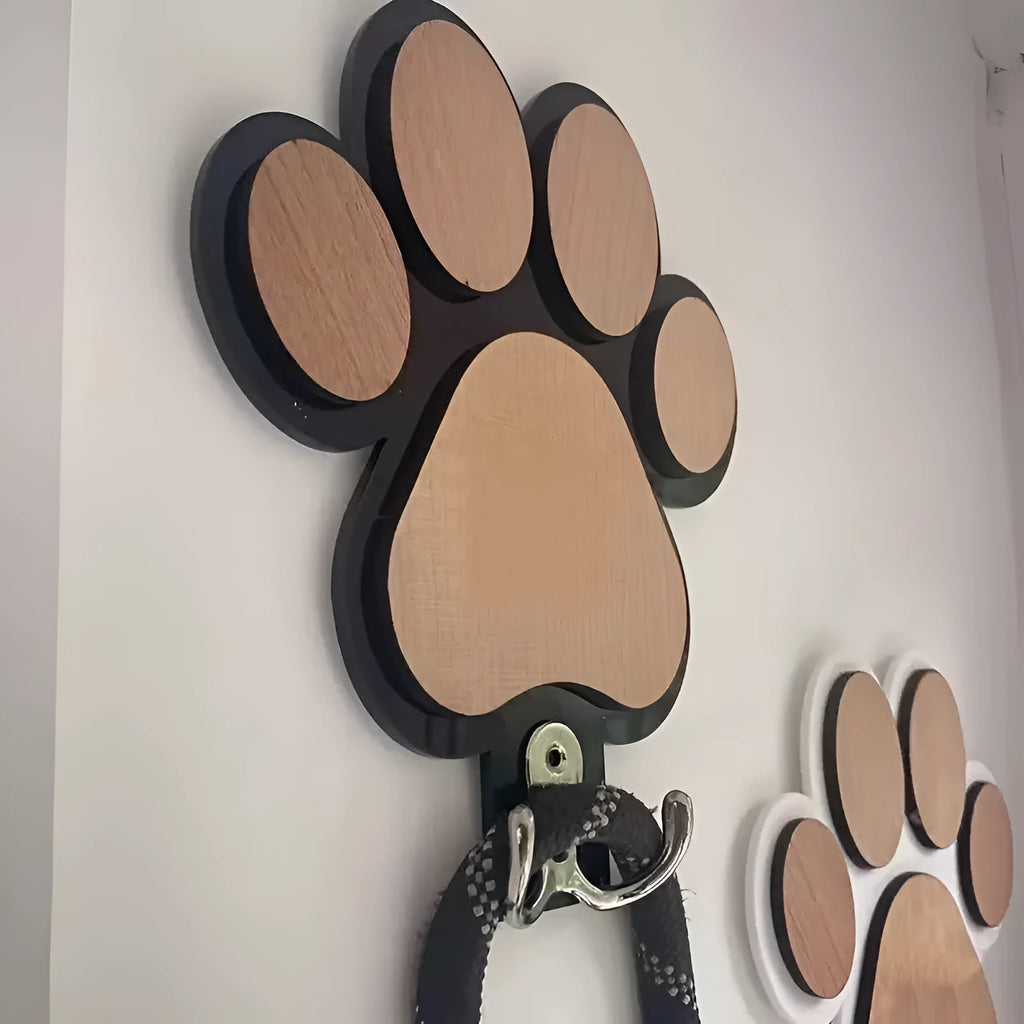 Wooden foot paw print wall hook in black on a white background, showing its shape and design.
